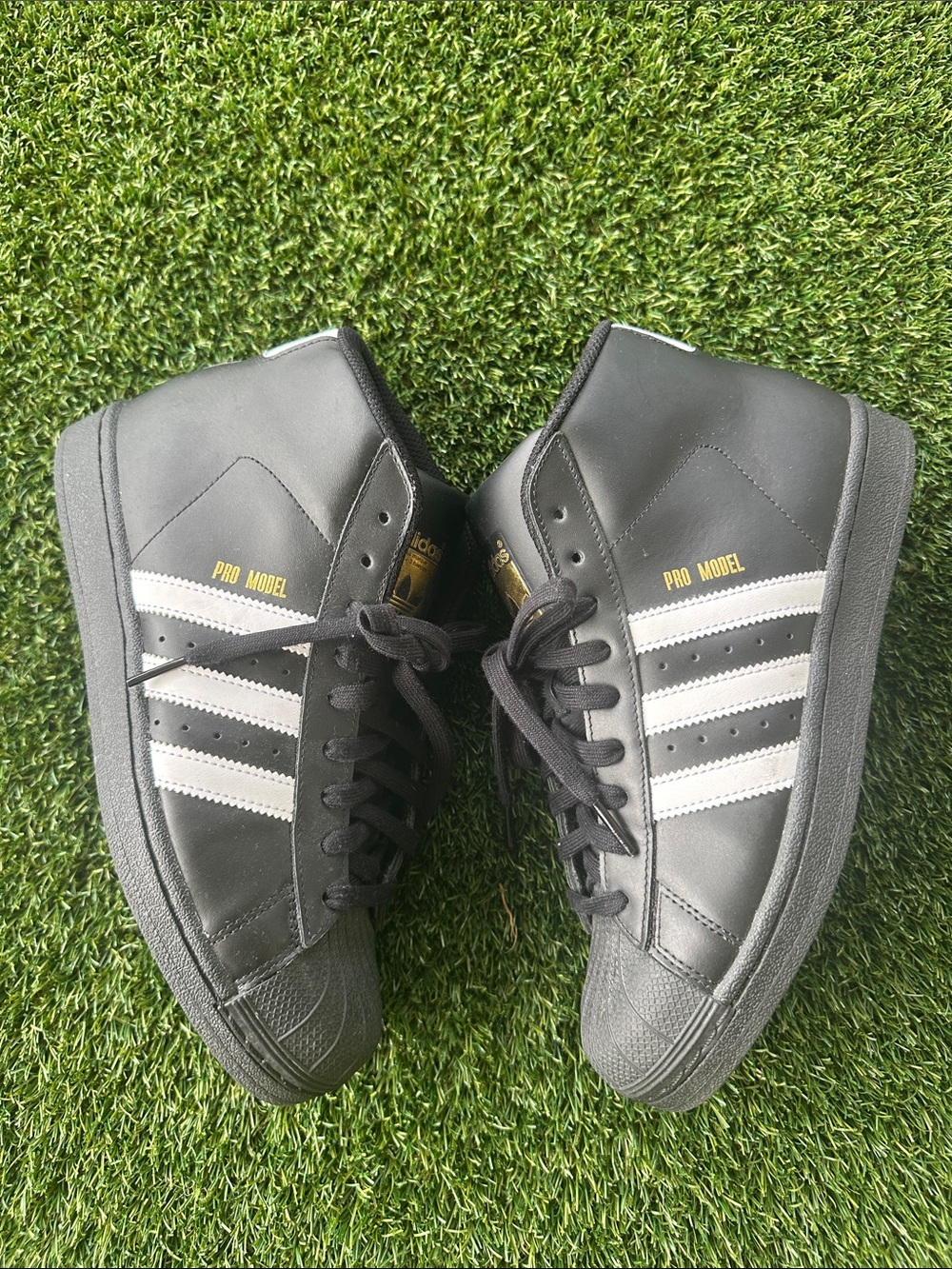 adidas Pro Model Mid-Top Sneakers in Black with White Stripes and Gold Logo